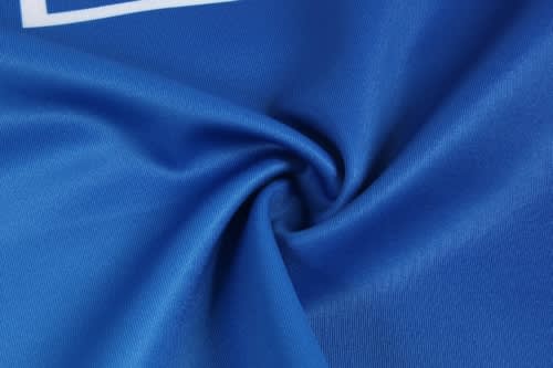 A blue sports jersey made from smooth fabric, featuring a texture that highlights its quality and stretch.