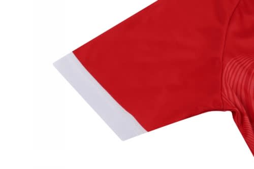 A red volleyball uniform with a white cuff on the sleeve and a logo prominently displayed.