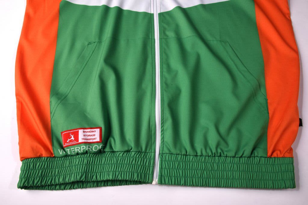 A water-repellent hoodie in vibrant green and orange, featuring a zippered front and elastic waistband, with a branded logo.