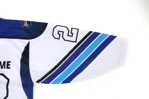A blue and white ice hockey jersey featuring a sleek design and a number on the sleeve. The jersey has a logo.