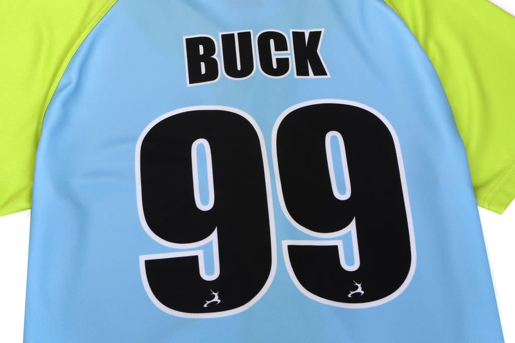 A blue and green full button baseball tee featuring the name "BUCK" and the number "99" on the back.