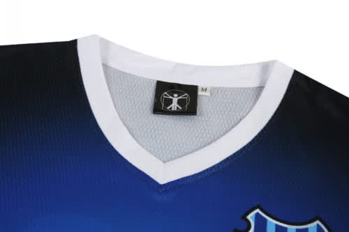 A sports jersey featuring a blue gradient design, with a white V-neck collar and a small logo.