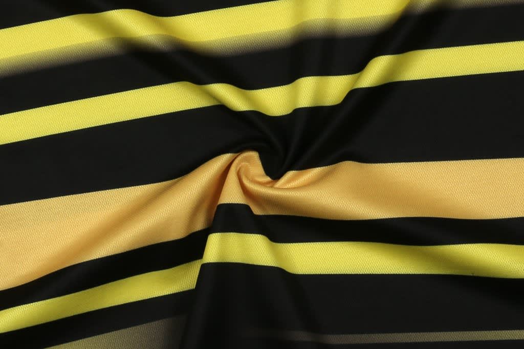 A striped fabric featuring bold black and yellow colours, arranged in horizontal lines. It has a smooth, silky texture.