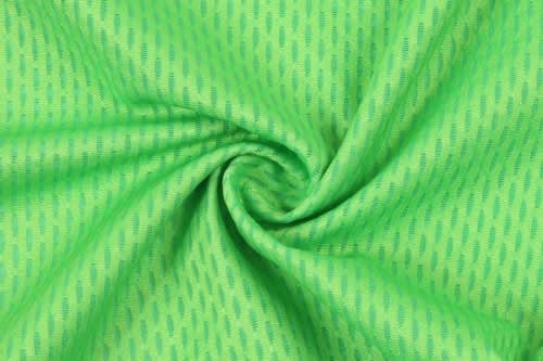 A bright green fabric with a textured pattern, showcasing a smooth, circular twist.