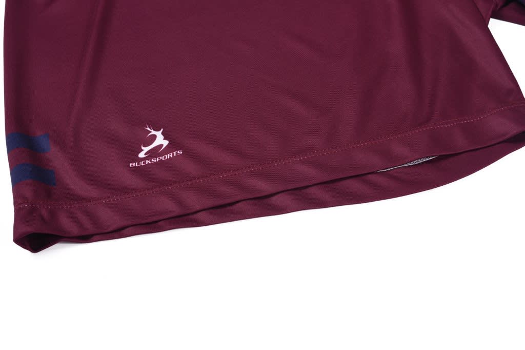 A maroon sports shirt featuring a logo and blue stripes along the hem.