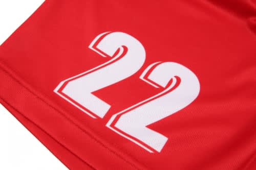 A red volleyball uniform featuring large white number "22" prominently displayed. It includes a logo.
