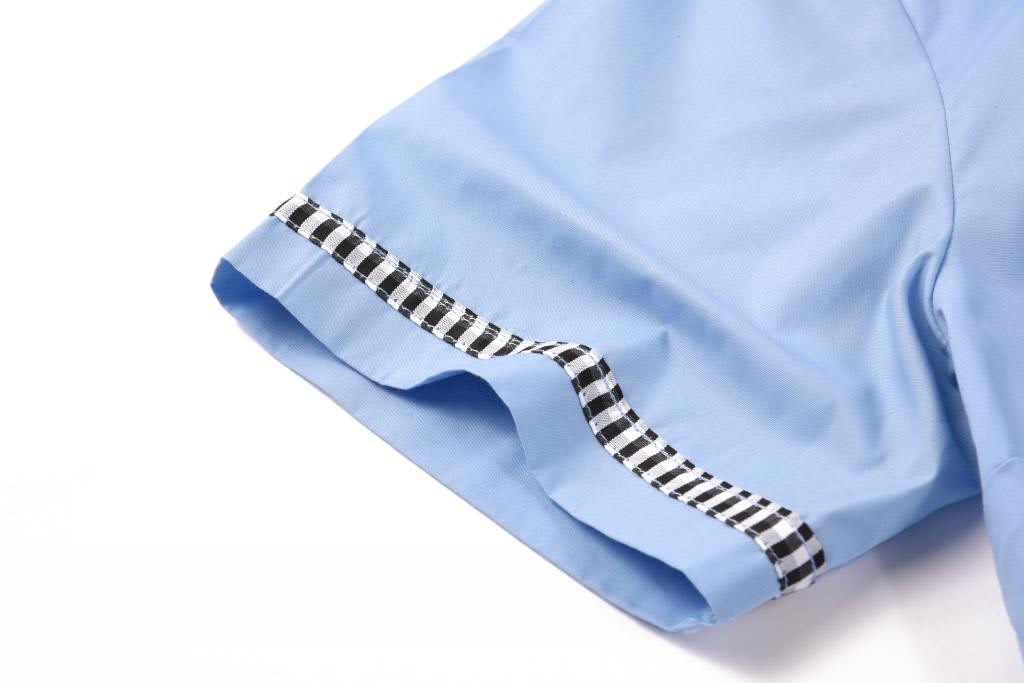 A light blue school shirt with a checkered trim on the hem and sleeves, featuring a brand logo.
