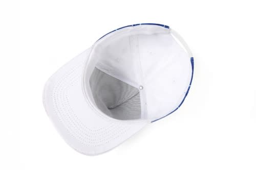 A white sport cap with a blue design on the peak, featuring a logo and a ventilated interior.