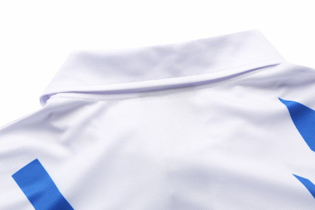 A white polo shirt featuring blue designs and a collar, with a logo on the fabric.