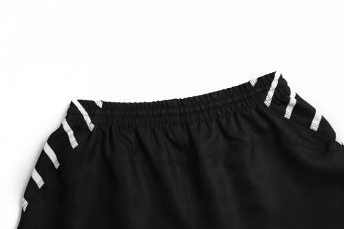 A black AFL player uniform with white stripes at the waist, featuring an elastic band and a logo.
