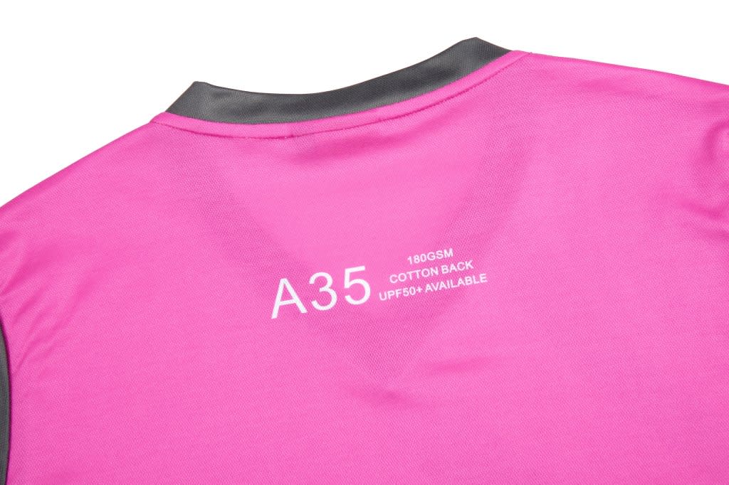 A pink sports team T-shirt with a grey collar and a logo on the back.