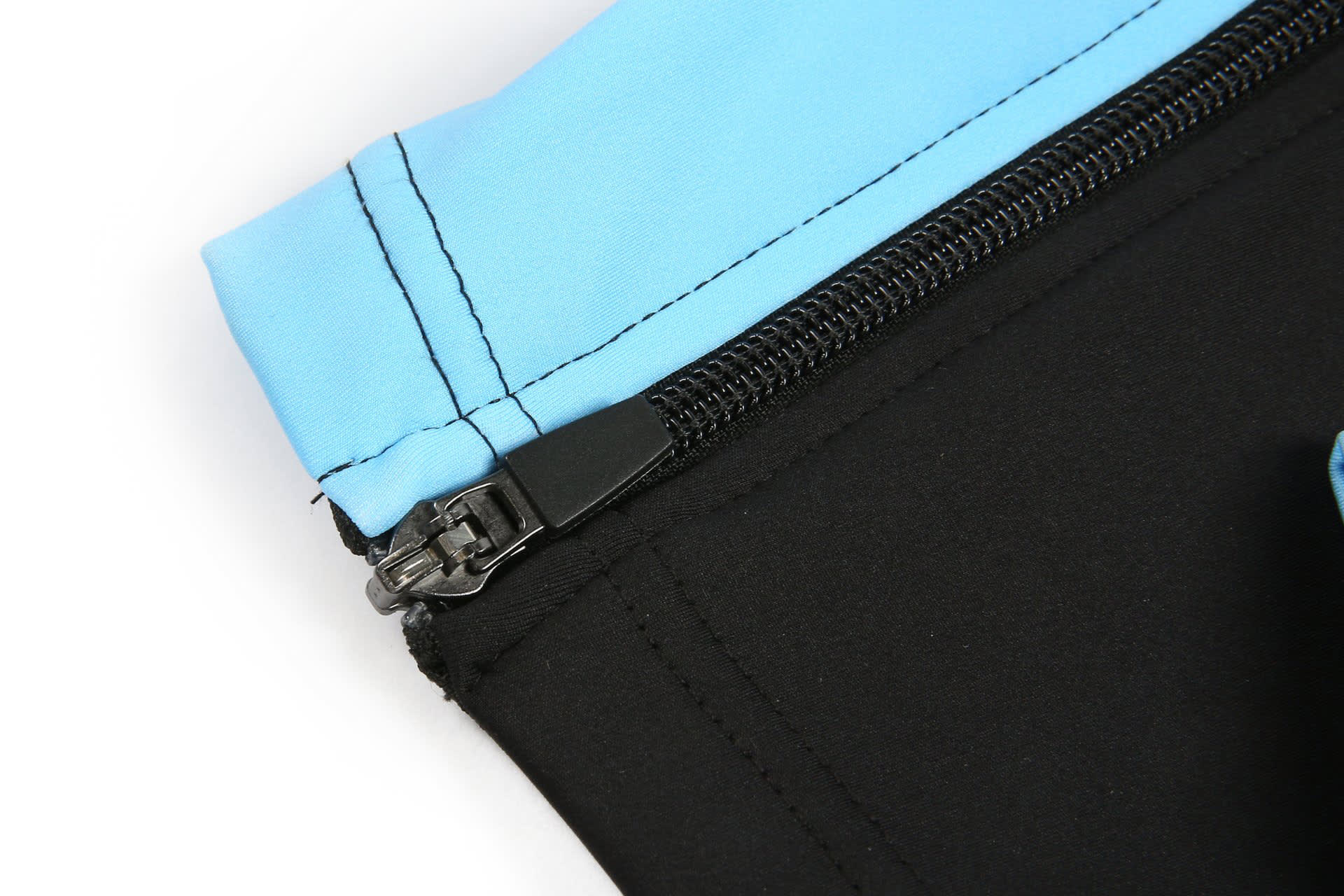 A black track suit with a light blue zippered collar and a logo on the fabric.