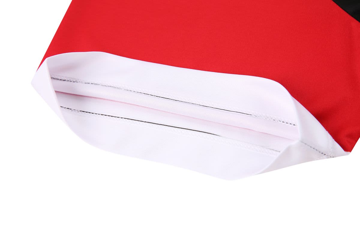 A red and white T-shirt featuring a cut-and-sew design, highlighting the bottom hem and stitching details.