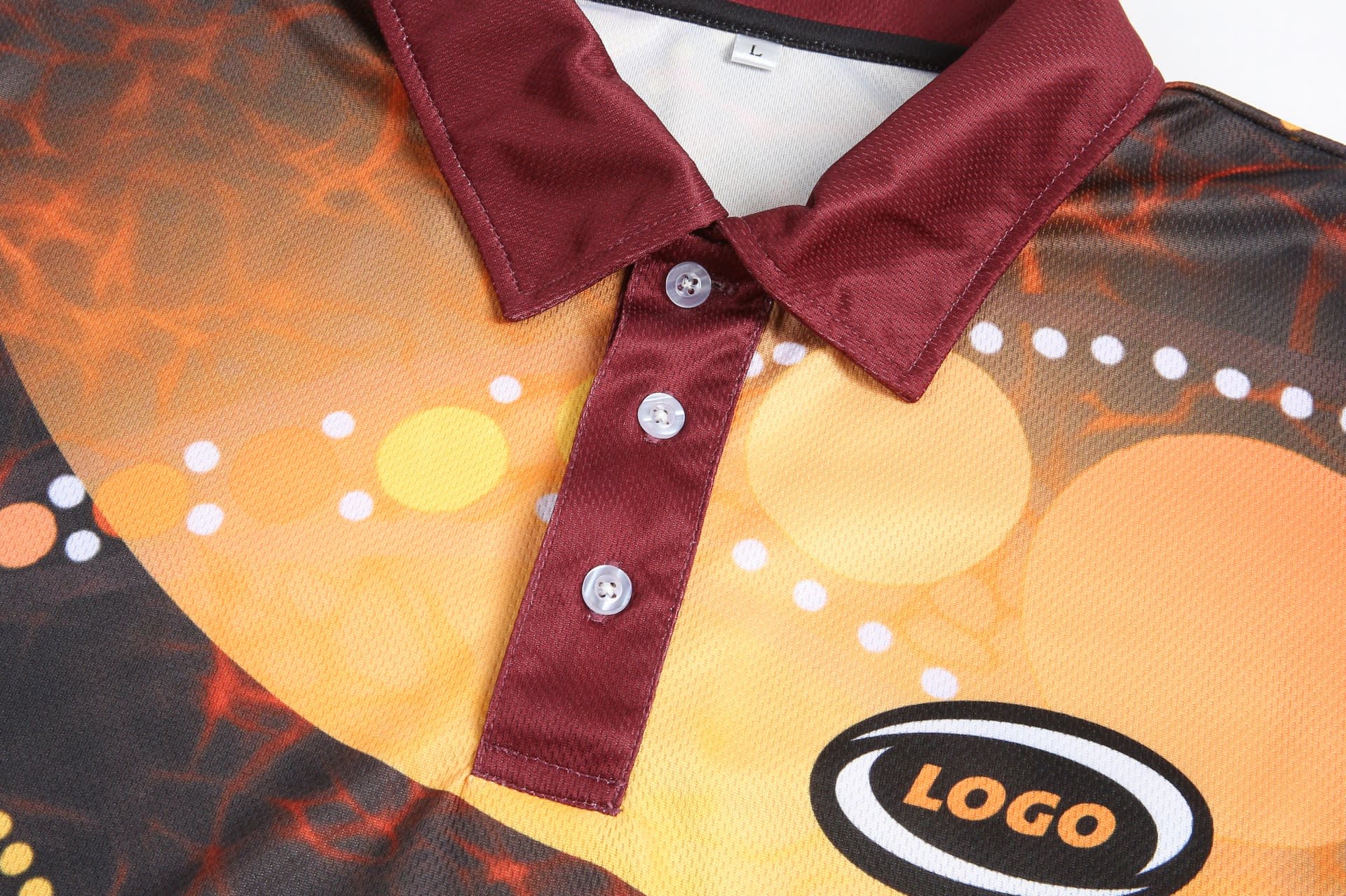 A customised Aboriginal polo featuring a vibrant design with shades of orange and maroon, and a logo on the side.