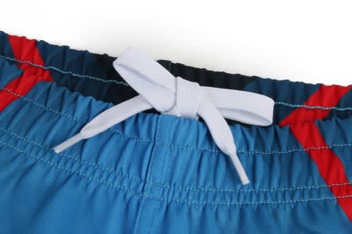 Blue and red rugby shorts featuring an elastic waistband with a drawstring. Includes a branding logo.