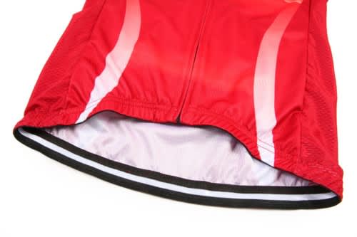 A red cycling uniform jersey with a smooth inner lining and contrasting white stripes. The jersey features a logo.