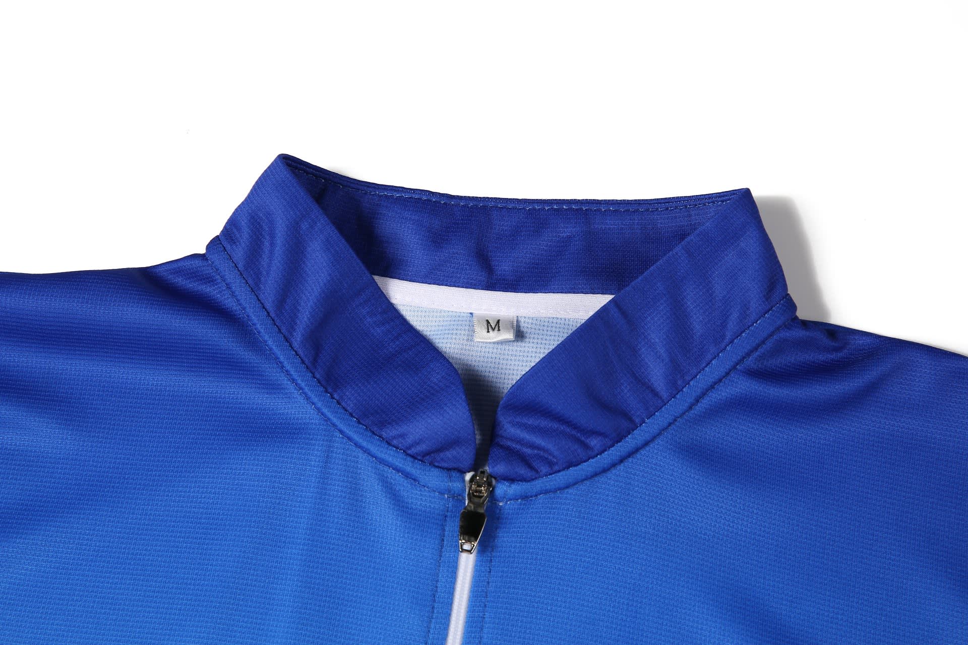 A blue lawn bowling uniform featuring a stand-up collar and zip closure. It has a size label inside.