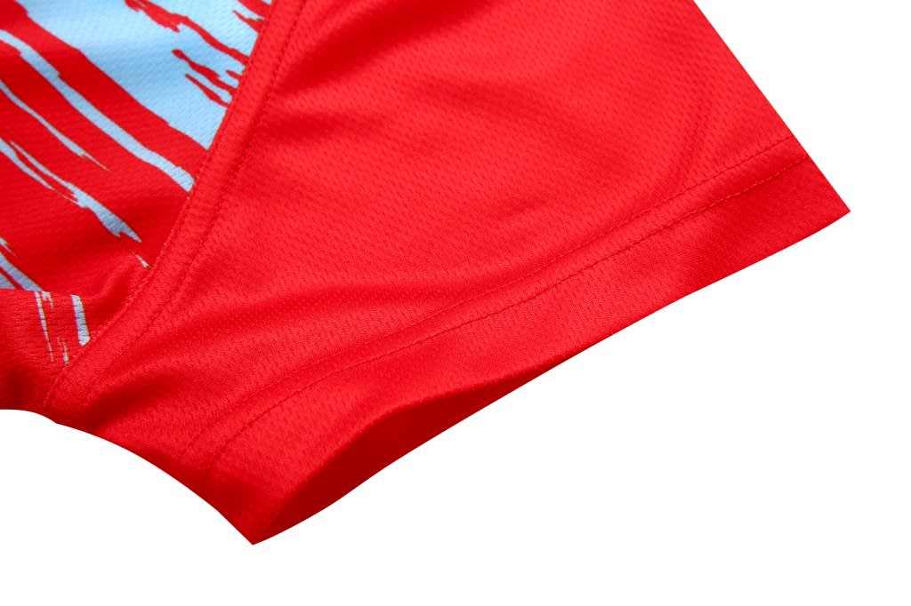 A red women's T-shirt with a blue abstract design at the shoulder seam, featuring a branding logo.