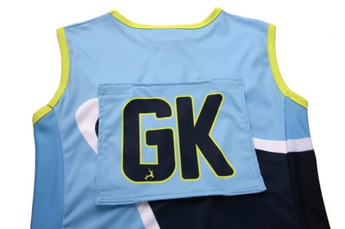 Custom netball bib in blue and navy, featuring a large "GK" on the back, with a logo present.