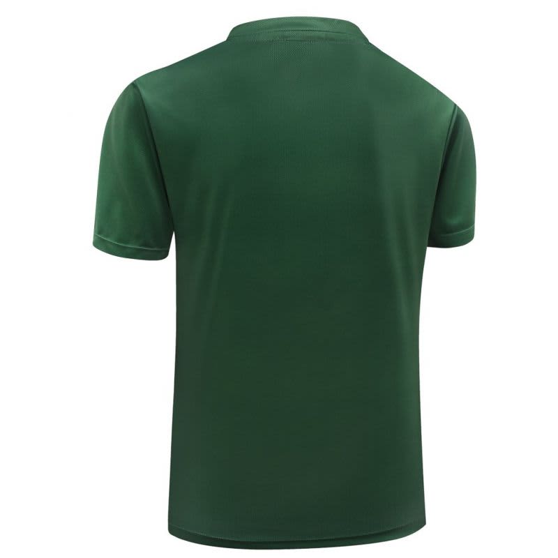 A green polo shirt with a plain back and short sleeves, featuring a logo on the upper back.