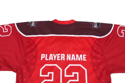 A red hockey jersey with a maroon yoke, featuring a logo and space for a player's name and number.