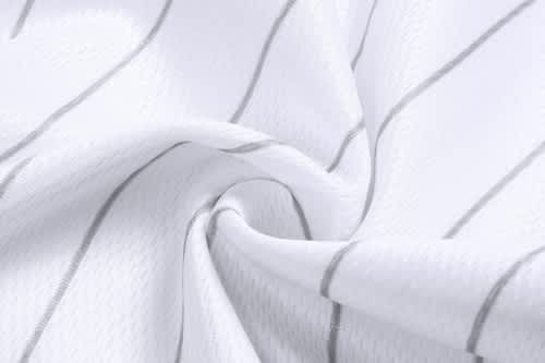 A close-up view of a white fabric with grey stripes, showcasing the texture of a sports jersey material.