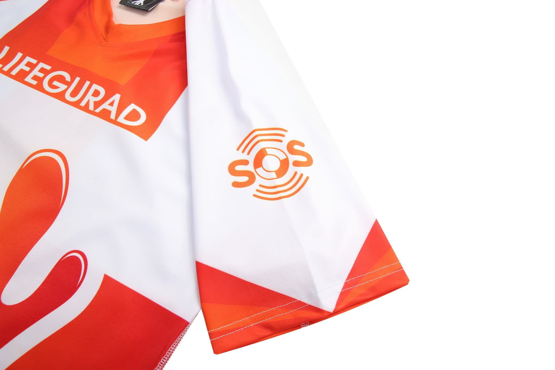 A sports uniform with red and white colours featuring a lifeguard design and a logo on the sleeve.