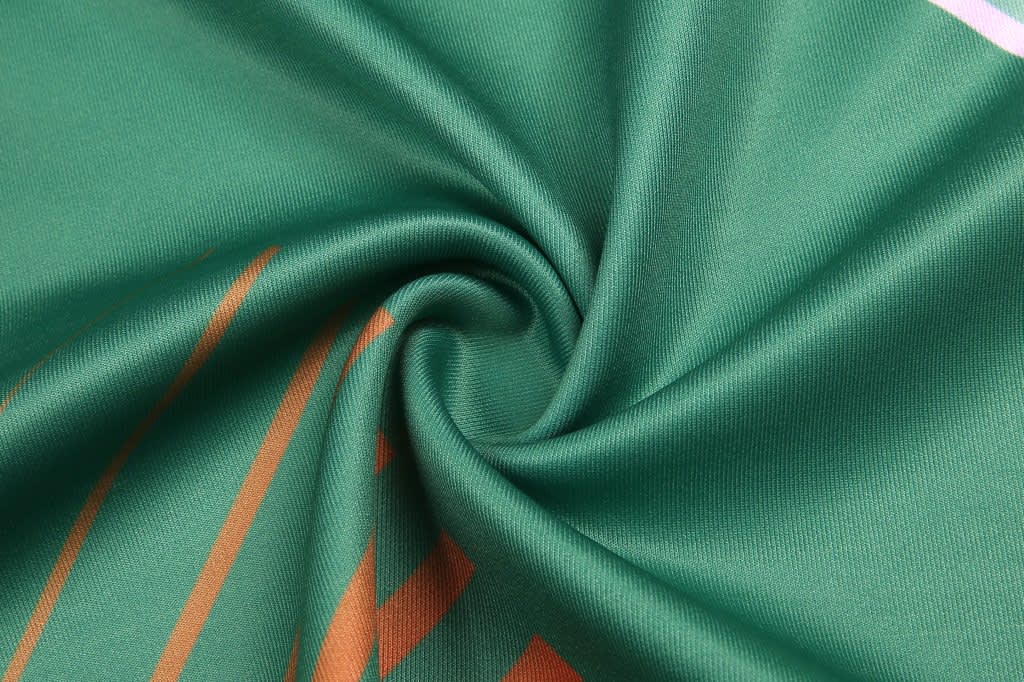 AFL vest in green fabric with orange stripes, featuring a smooth, folded texture. Includes a logo.