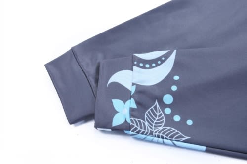 A dark grey jacket sleeve with a blue floral design and a logo.