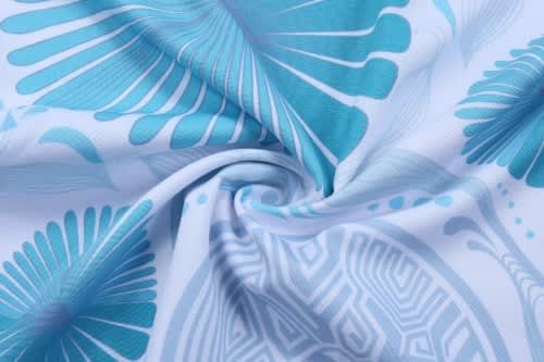 A close-up of fabric featuring a swirl design in shades of blue and white, showcasing a soft, patterned texture.