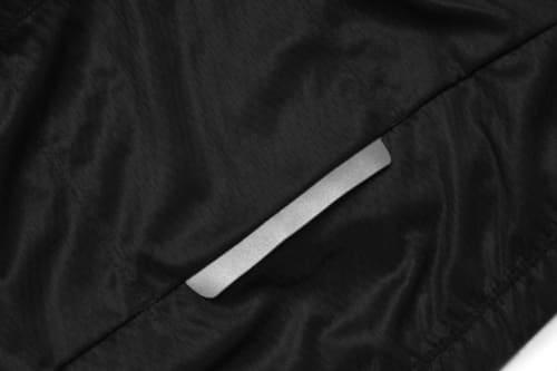 A close-up of a black sports jersey fabric with a smooth texture and a subtle reflective strip.