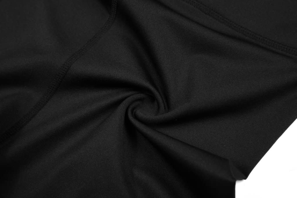 Black anti-slip shorts with a smooth, wrinkle-free fabric lying flat. Features a logo on the waistband.
