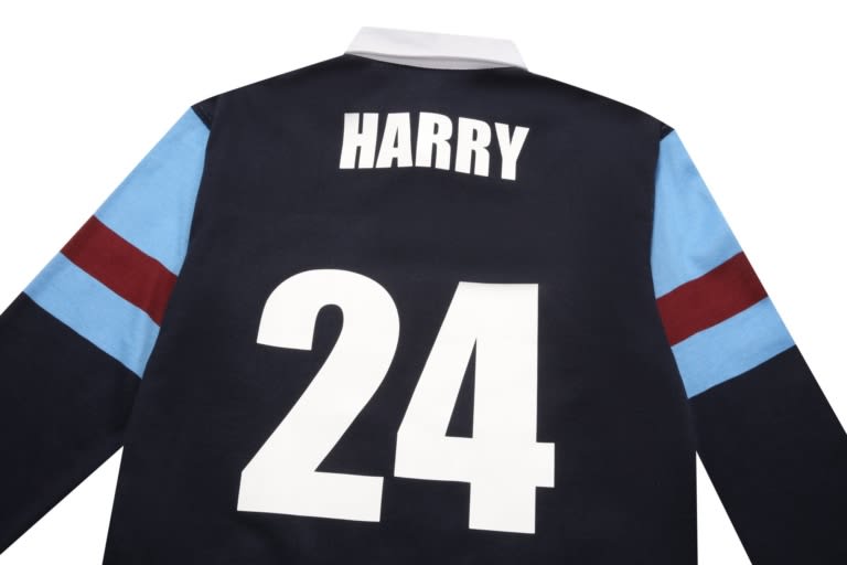 A black sports jumper featuring blue and maroon sleeves, with a large white number 24 and the name Harry.