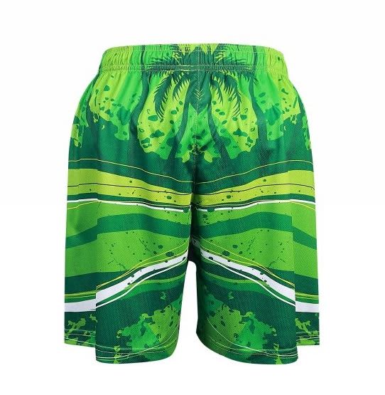 A pair of green shorts featuring a tropical pattern with stripes and abstract designs.