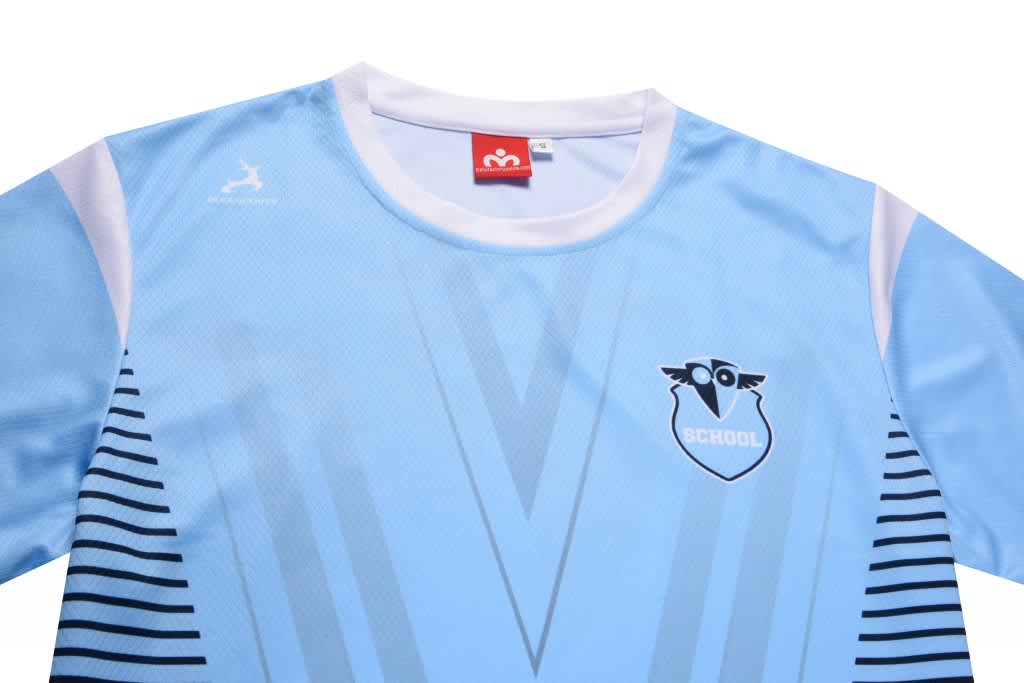 A light blue round neck tee featuring a simple design with a logo and striped pattern along the sides.