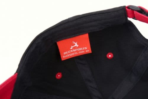 A red and black sublimated sport cap featuring an interior label and a branded logo.