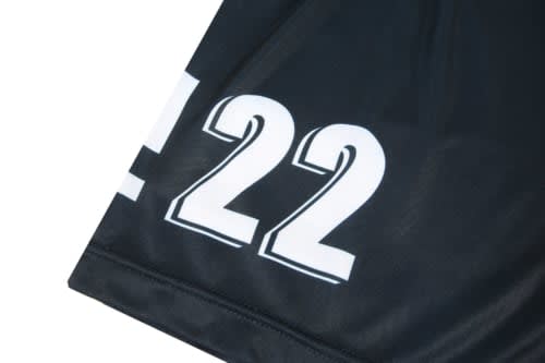A black volleyball uniform featuring a large white number '22' and a logo on the fabric.