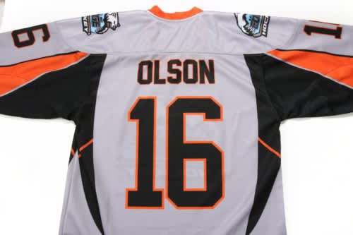 A grey ice hockey jersey featuring orange and black accents, with the name "OLSON" and the number "16" displayed prominently.