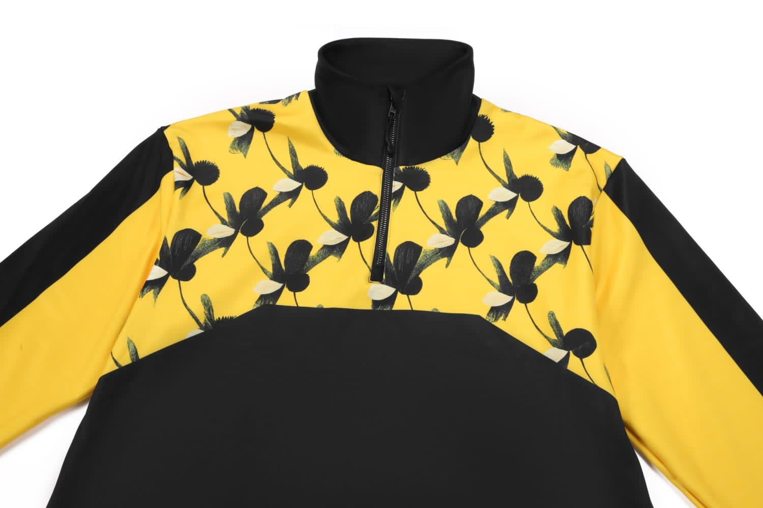 A pullover jumper featuring a vibrant yellow base with black floral patterns and black accents on the sleeves.