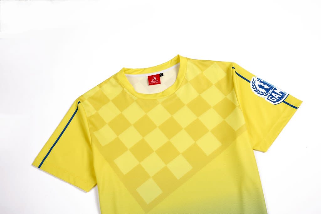 A bright yellow CHESS CLUBWEAR SHIRT featuring a checkerboard pattern and a logo on the sleeve.