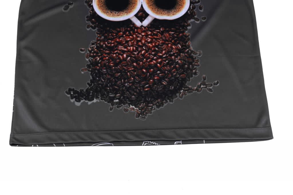 A camouflage polo featuring a design of coffee beans arranged to form an owl, with a dark background.