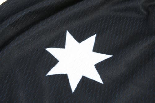 A black sports jersey featuring a white star logo. The fabric has a textured pattern.
