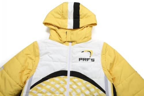 Yellow winter coat with removable sleeves and hood, featuring a logo and patterned design.