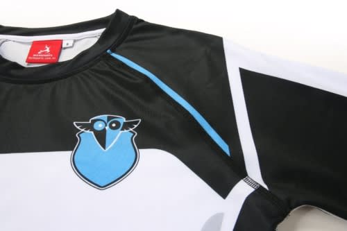 A sports uniform in black and white with blue accents and a logo on the front.