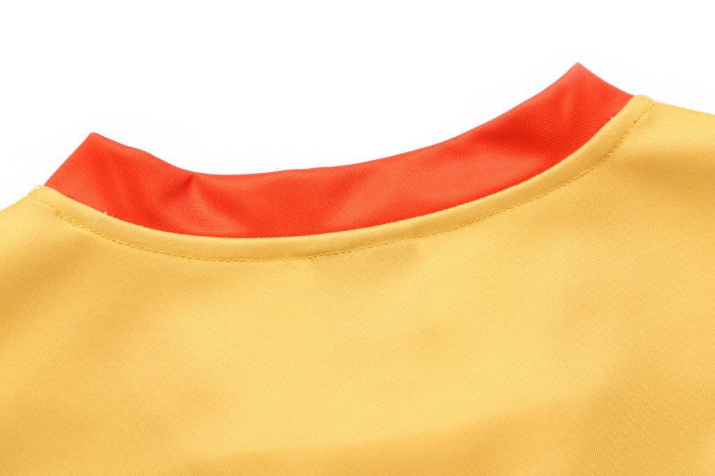 A bright yellow AFL singlet with a red collar, featuring a logo on the fabric.