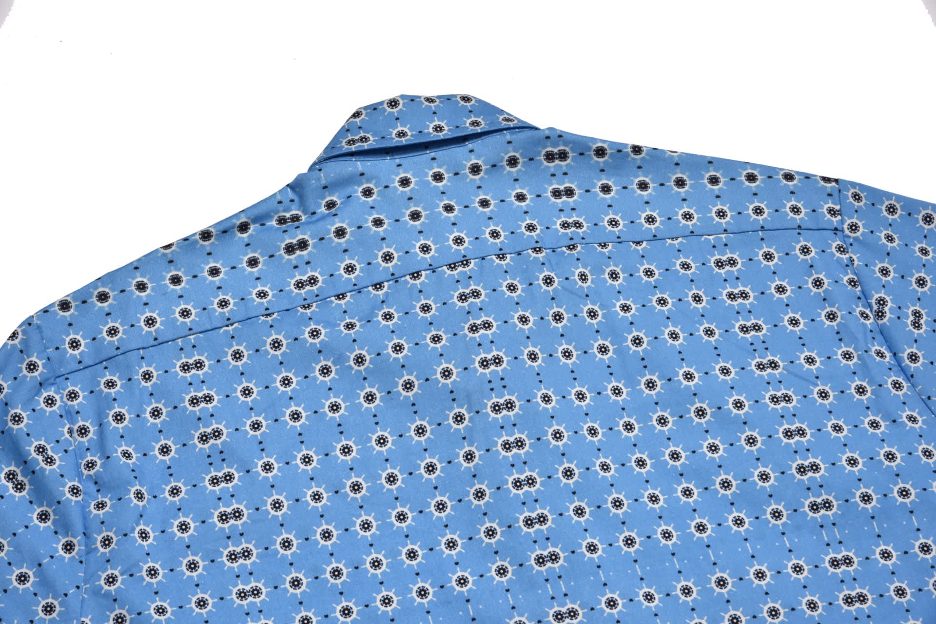 A checked shirt in blue with a floral pattern and a branding logo on the back.