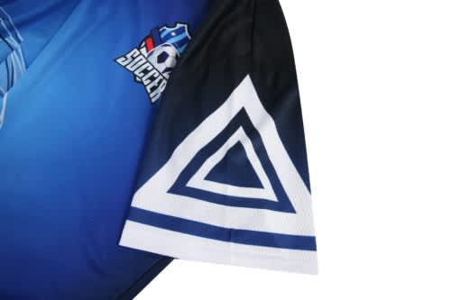 A blue and black soccer jersey featuring a logo and a triangular design on the sleeve.