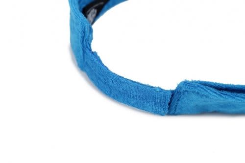 A blue soft peak visor with a textured fabric, featuring a simple design and no visible branding.