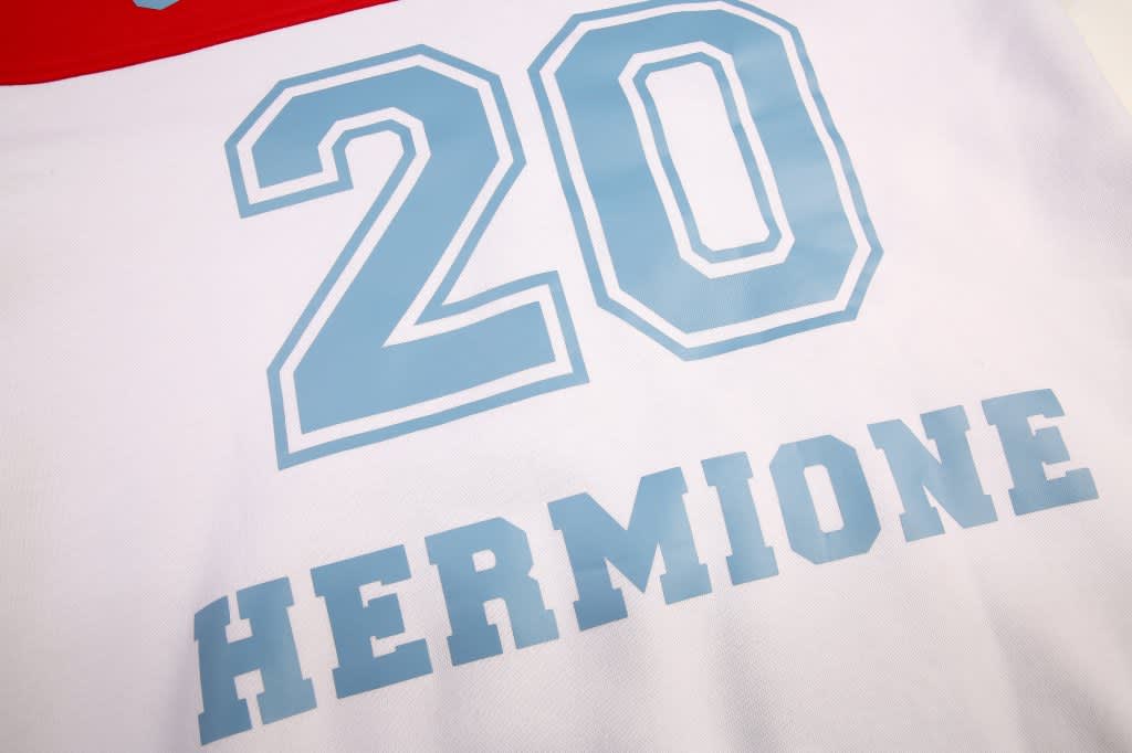 A white fleece hoodie featuring a large blue number "20" and the name "HERMIONE" in bold letters.