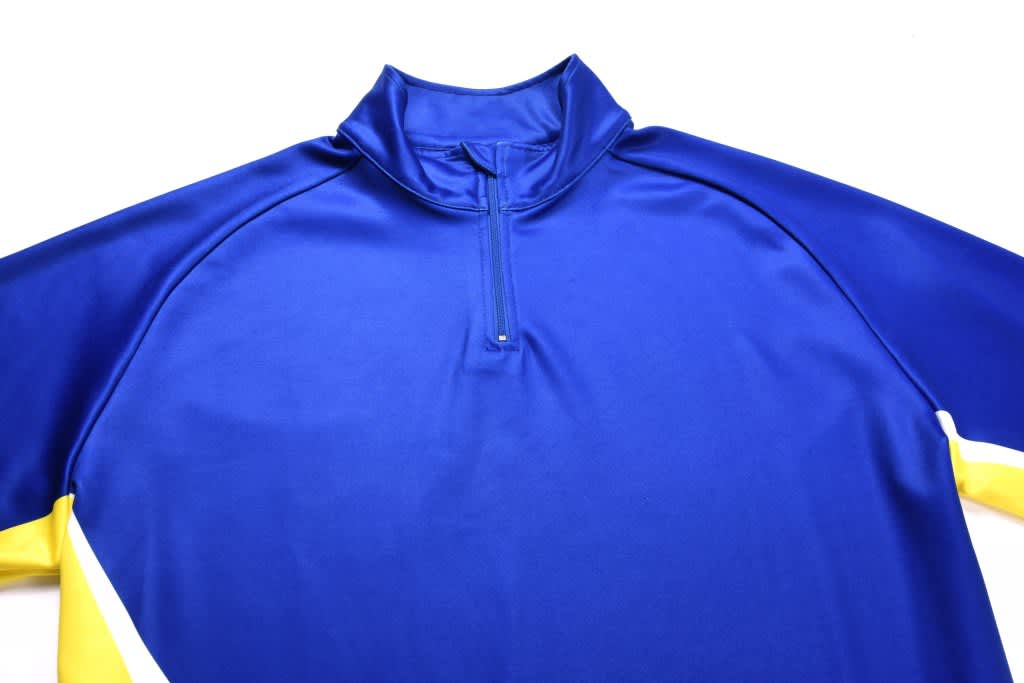 A blue and yellow sublimated pullover featuring a half zip and a collar, with a logo present.